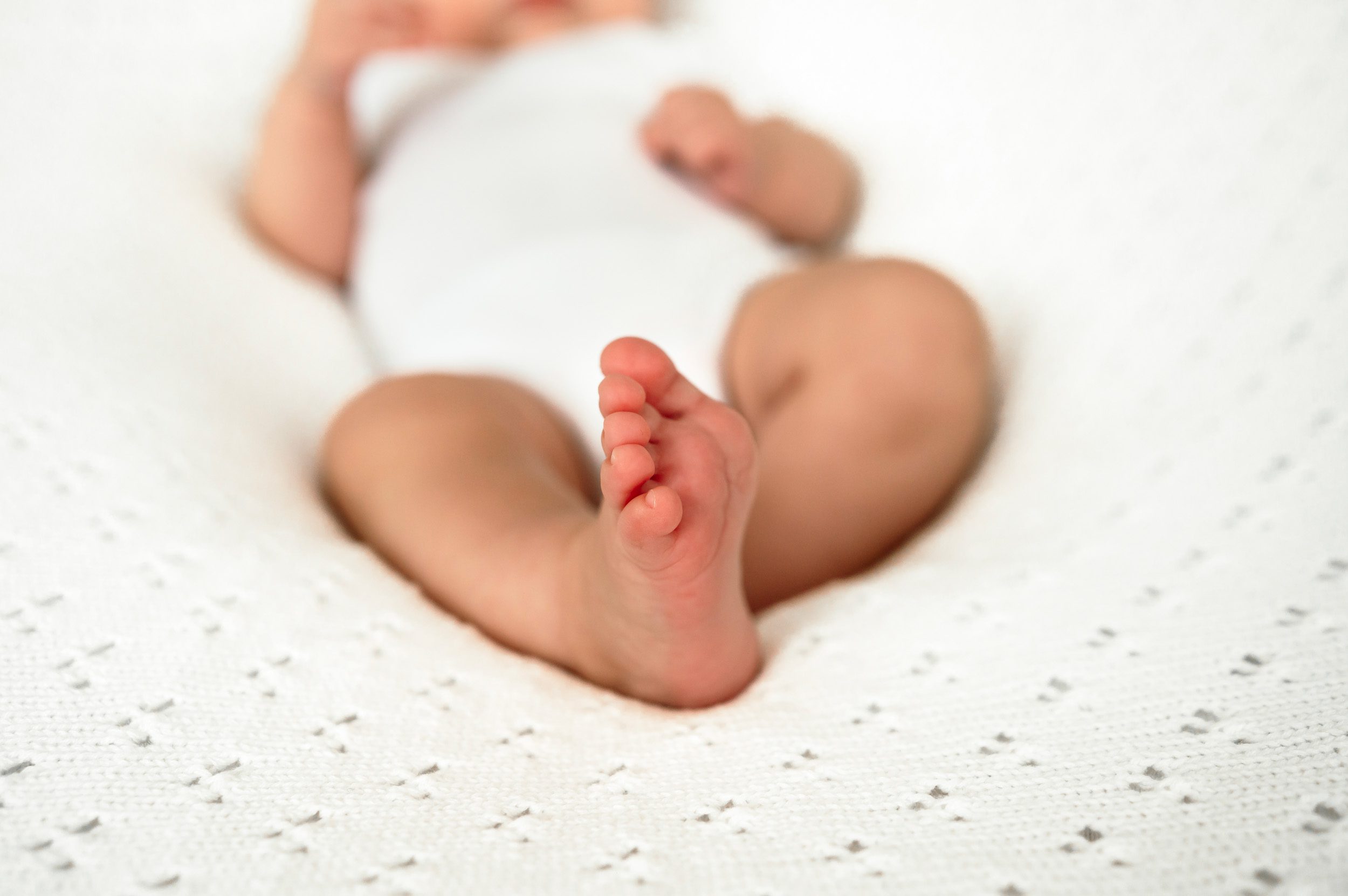 Close-up detail shot of newborn baby girl's toes during a home newborn photoshoot
