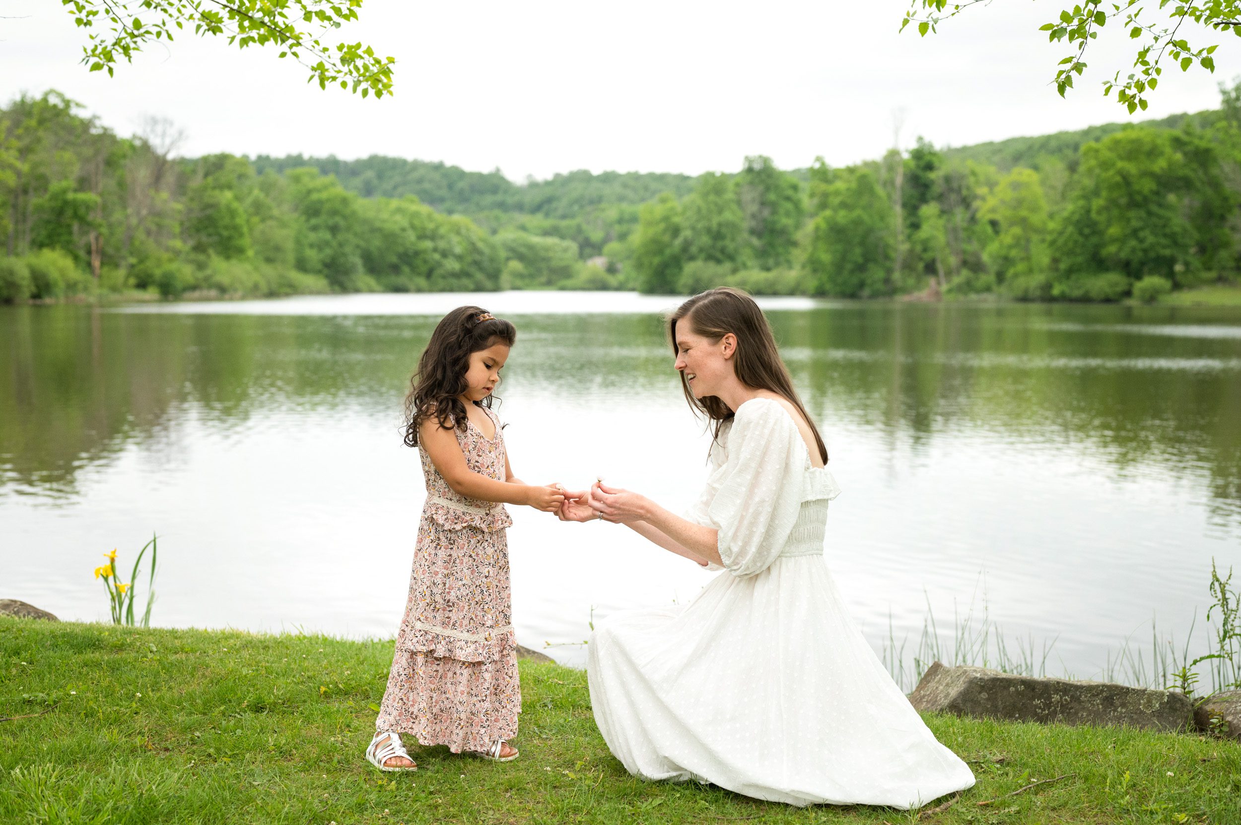 A young girl handing her mom a flower during a pottstown family photo session